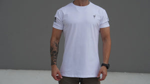 Person wearing a white t-shirt with a No Straight Path® logo on a gray background