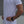 Person wearing a white t-shirt with star patterns on sleeves against a neutral background