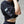 Person wearing a black athletic outfit with white graphics on a neutral background