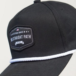 Black cap with a patch featuring 'No Straight Path' text on a light gray background