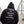 Person wearing a black hoodie with motivational text on the back, standing on stairs.