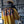 Person wearing a yellow 'NSP' shirt in a gym setting