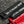 Black and red strap with No Straight Path® text on a textured surface